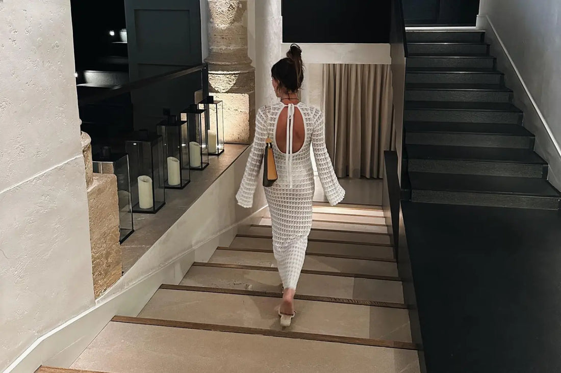 Bachelorette brunch outfit styled by a woman walking down modern stairs.