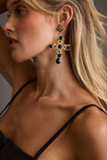 Black earrings with refined detailing and an elegant finish.
