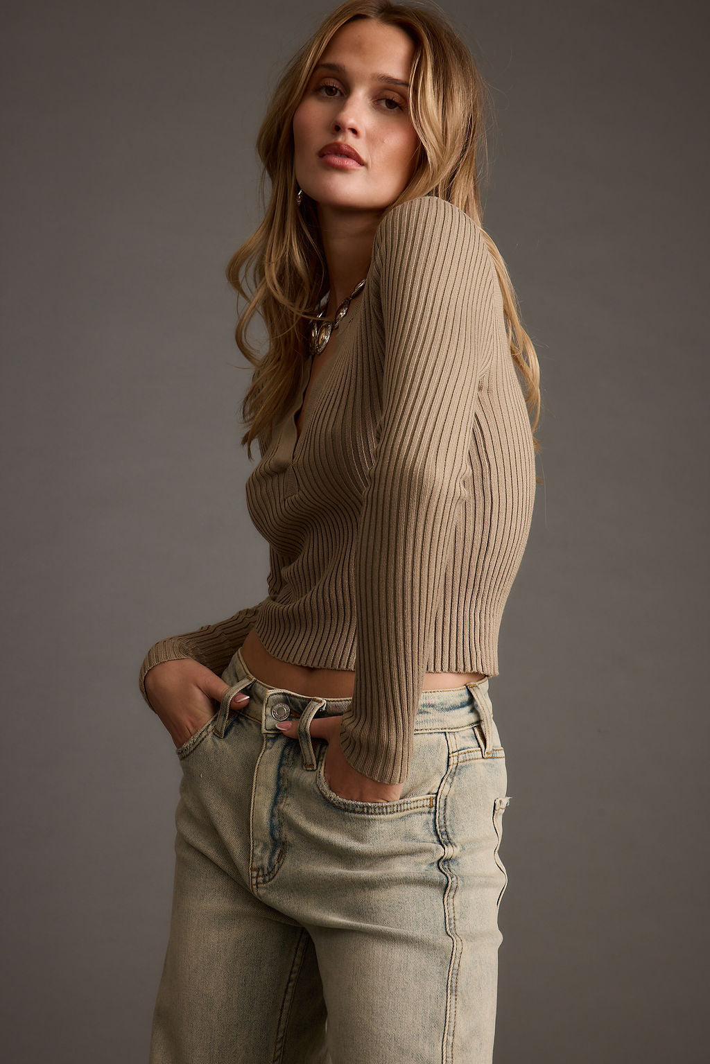 Detail shot of the Aurora Taupe Long Sleeve Ribbed Knit Top highlighting the knit and ribbed elements.