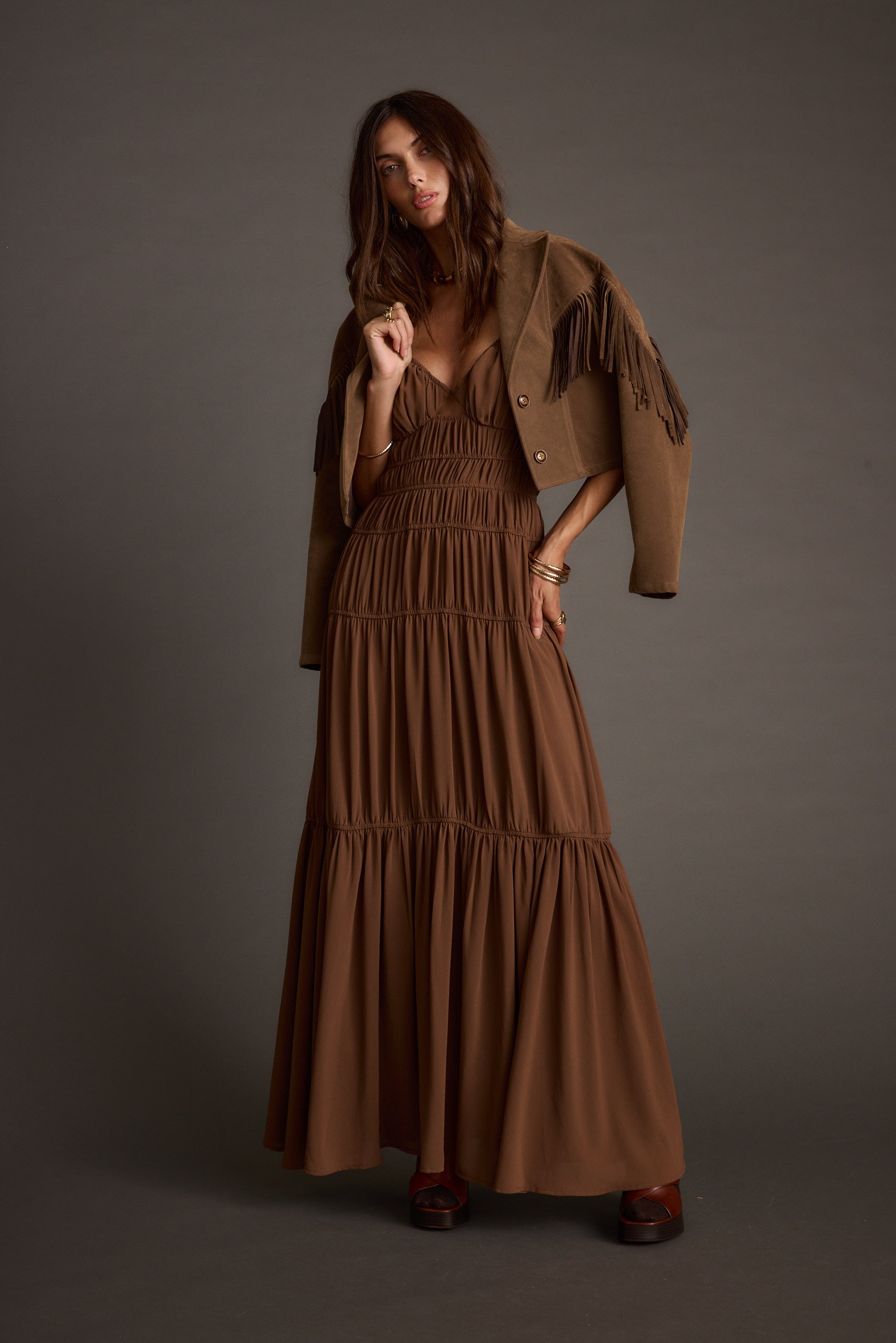 Full-length view of the mocha maxi dress showing the drape and movement.