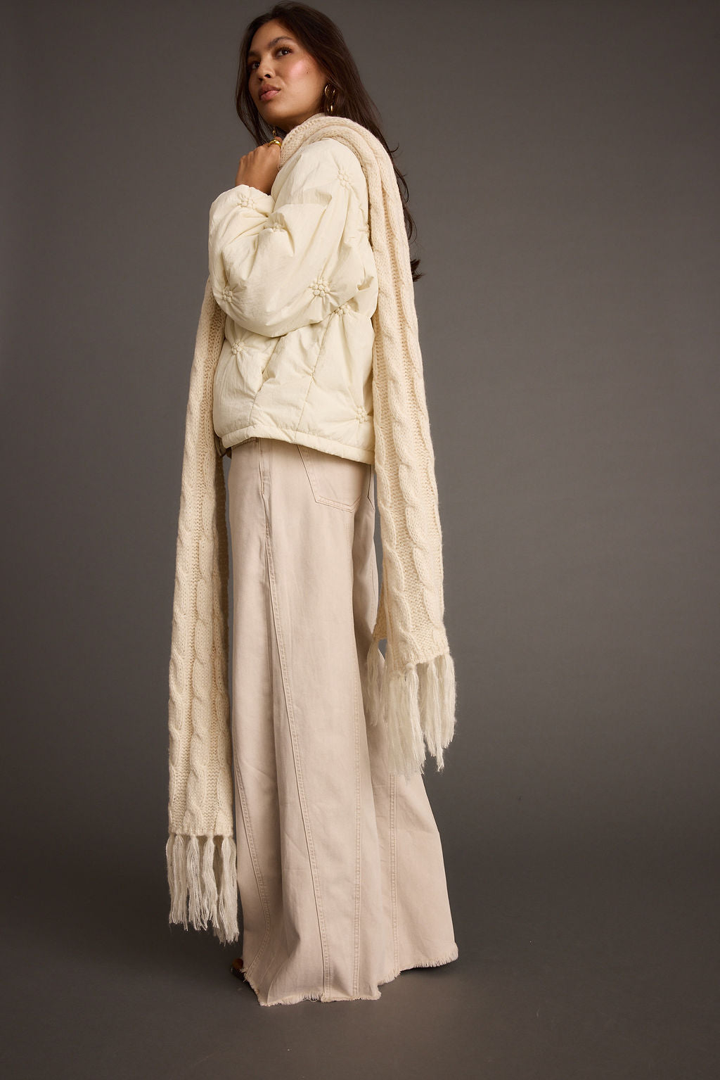 Full-length view of the cream piece showing the drape and movement.