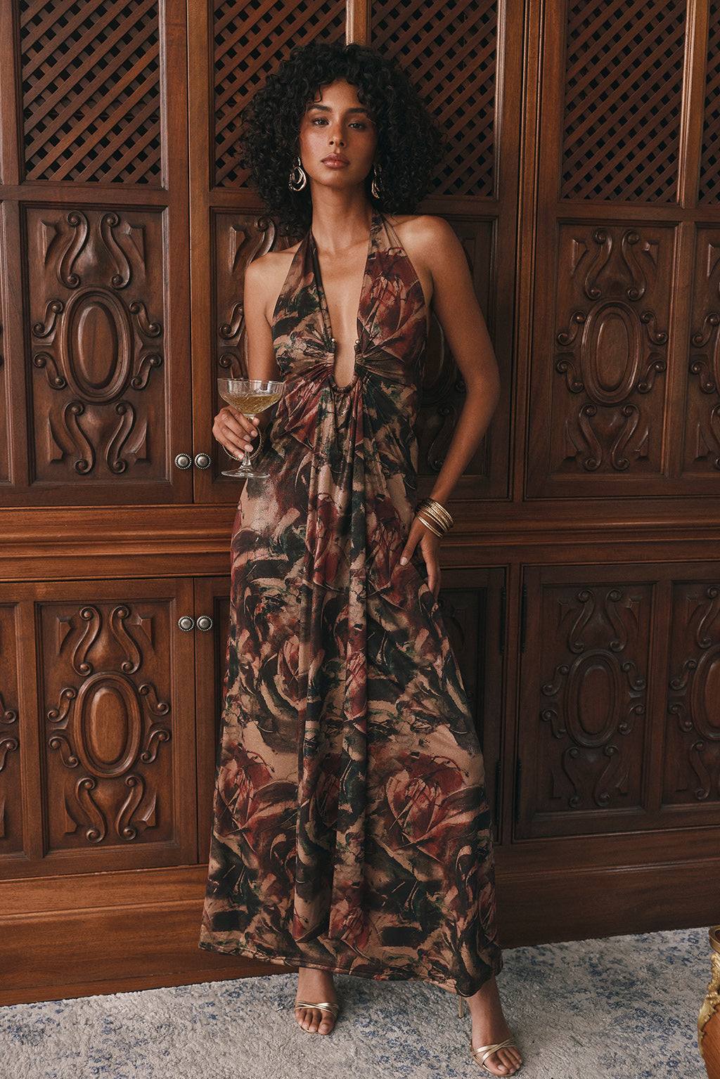 Metallic floral halter maxi dress with a plunging neckline and open back detail.