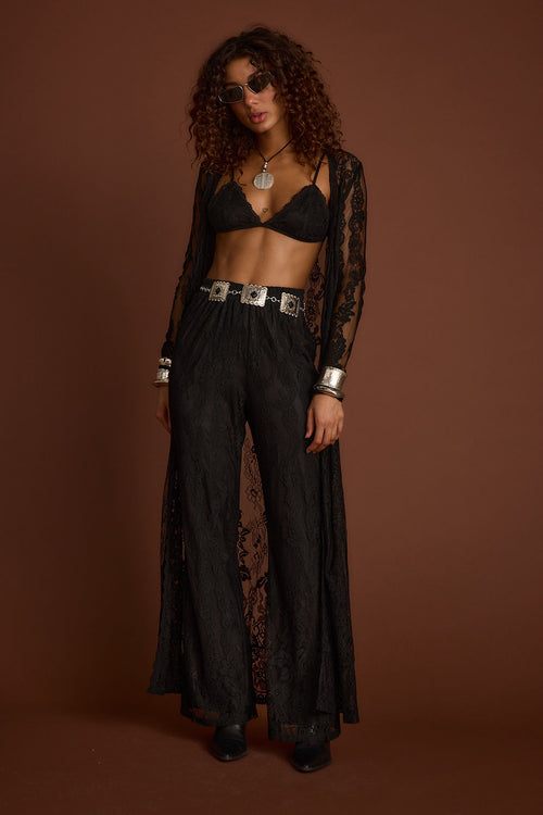 Black lace pants with refined accents, a black lace skirt essential.