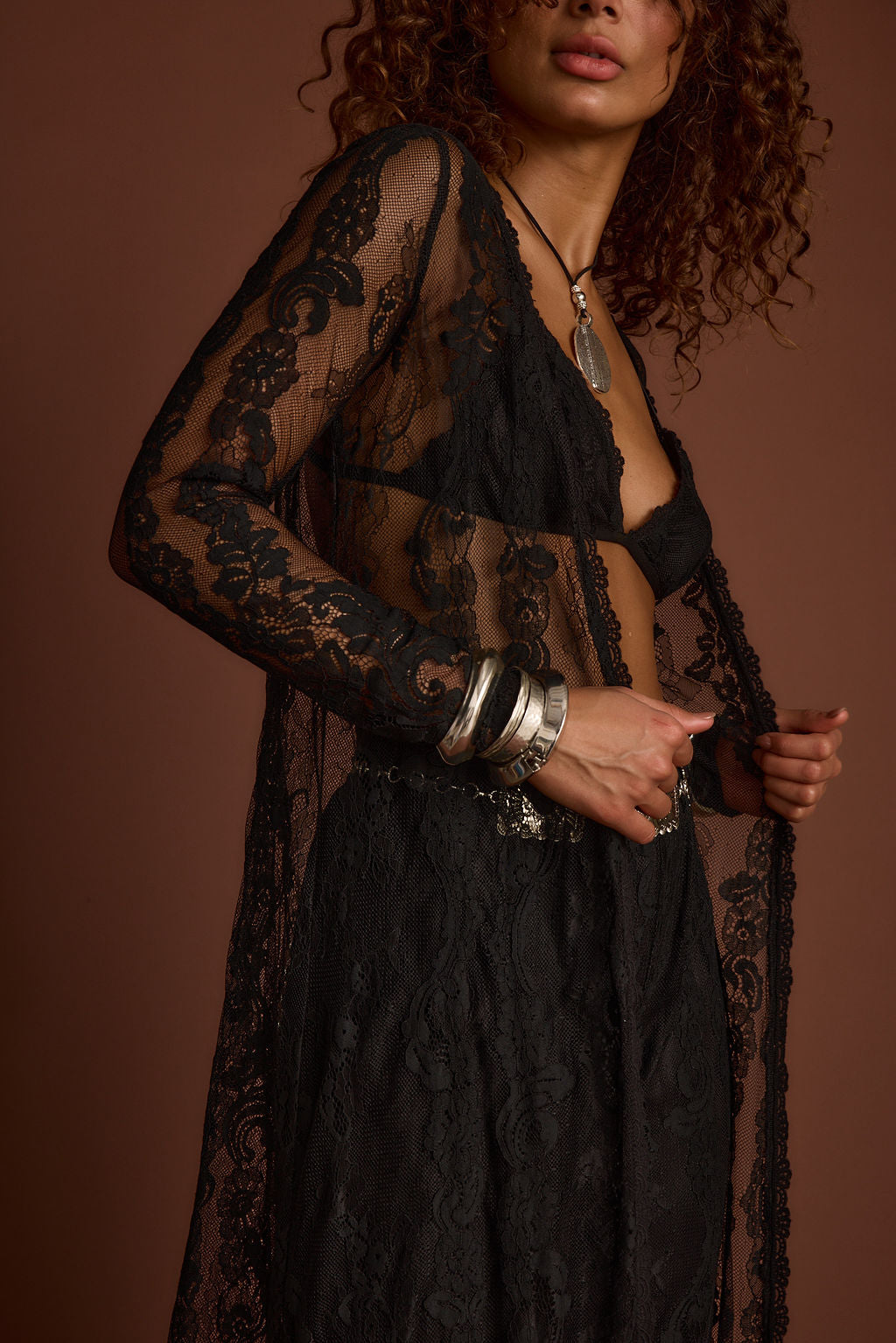 Full-length view of the black piece showing the drape and movement.