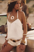 Model wearing the 12th Tribe Annabel Ivory Sequin Halter Top, a mid-length halter in flowy chiffon featuring a low back and sequin trim along the neckline, perfect for summer soirées, desert escapes, and stylish warm-weather looks this festival season