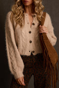 Cropped cardigan in oatmeal cable knit with tortoise buttons, styled with leopard print pants