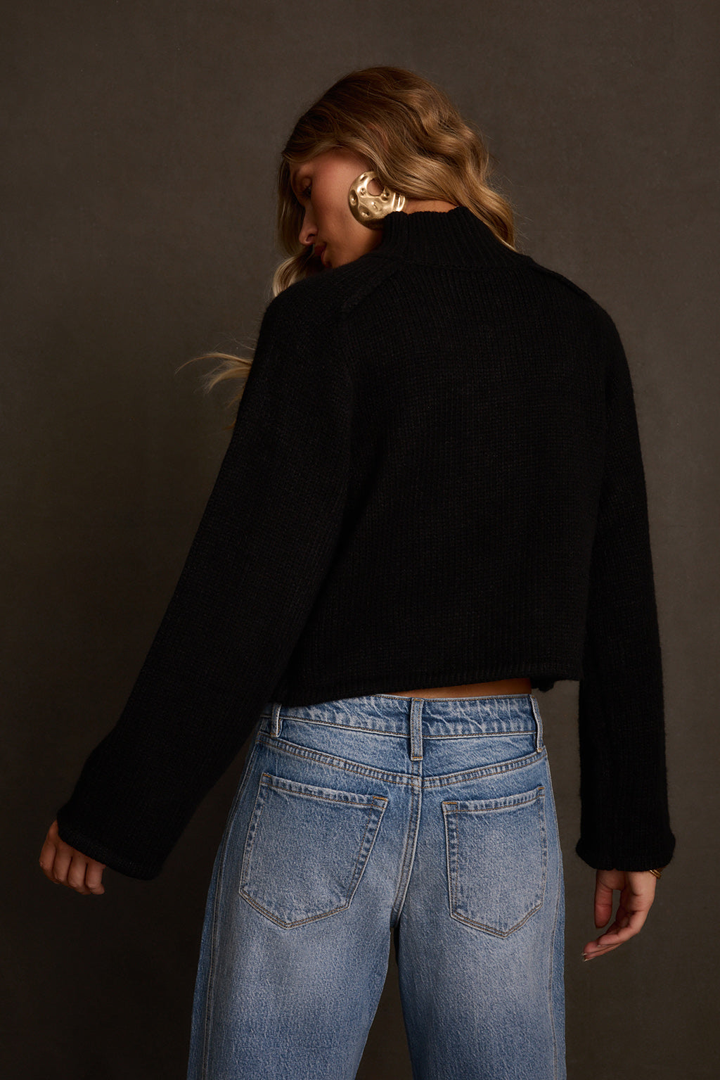 Cropped top outdoor shot layered with gold jewelry, barrel jeans, and western belt