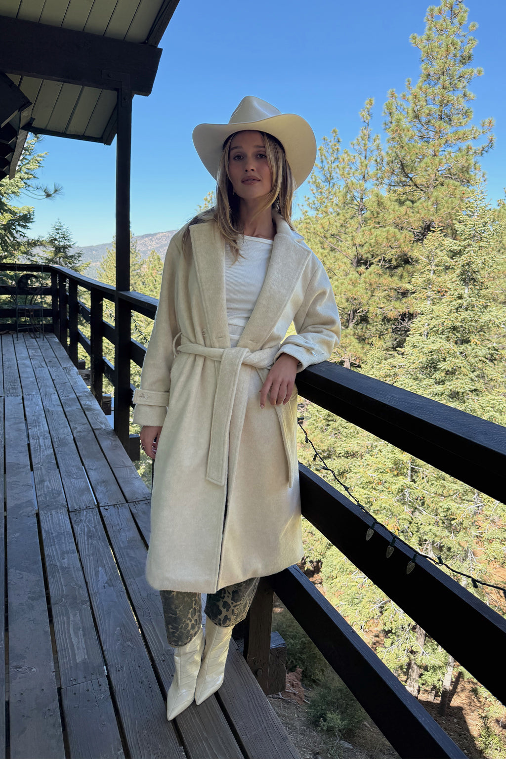 Lifestyle shot of the ivory jacket styled for day-to-night versatility.