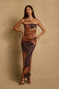 Strapless mocha floral maxi dress with side ruching, styled with gold jewelry and heels.