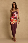 Model wearing the 12th Tribe Avani Plum Floral Maxi Dress in rich plum tones, featuring a floral print and flowing maxi silhouette, styled with strappy heels for weddings, Spring garden parties, and evening events