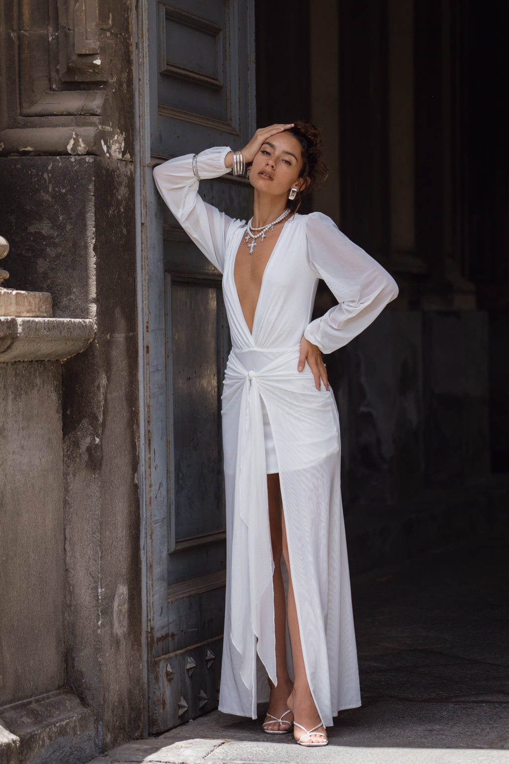 Full-length view of the white maxi dress showing the drape and movement.