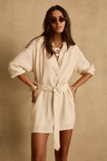 Model wearing the 12th Tribe Barcelona Natural Belted Dress in soft natural tones, featuring a relaxed silhouette with a cinched belted waist, styled with sandals and minimal accessories for brunches, travel, and resort wear