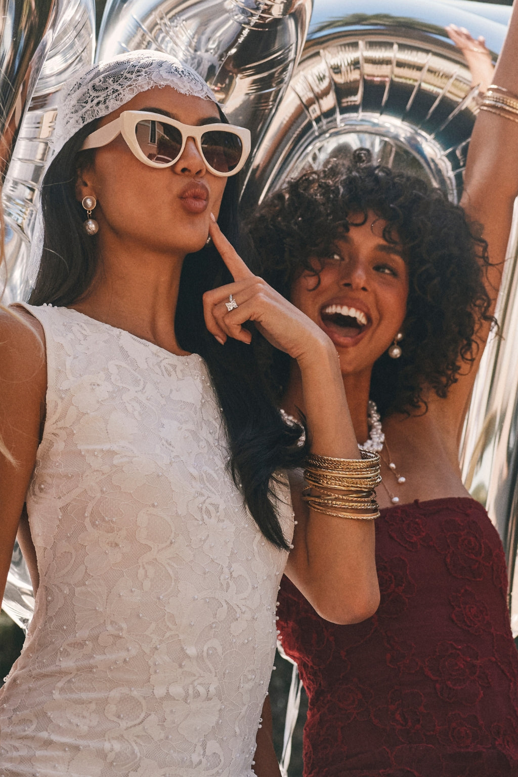 Two models wearing double pearl drop earrings, one with a lace veil and one with a beaded necklace.