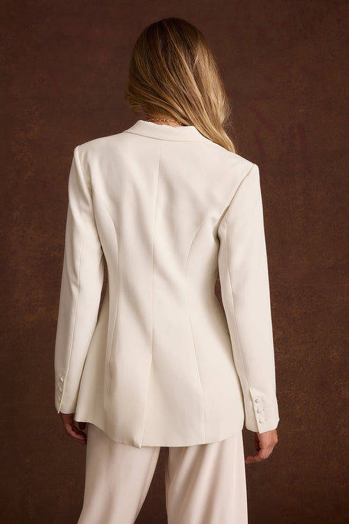 Back view of the Chloe white tapered blazer with seamed waist and buttoned cuffs.