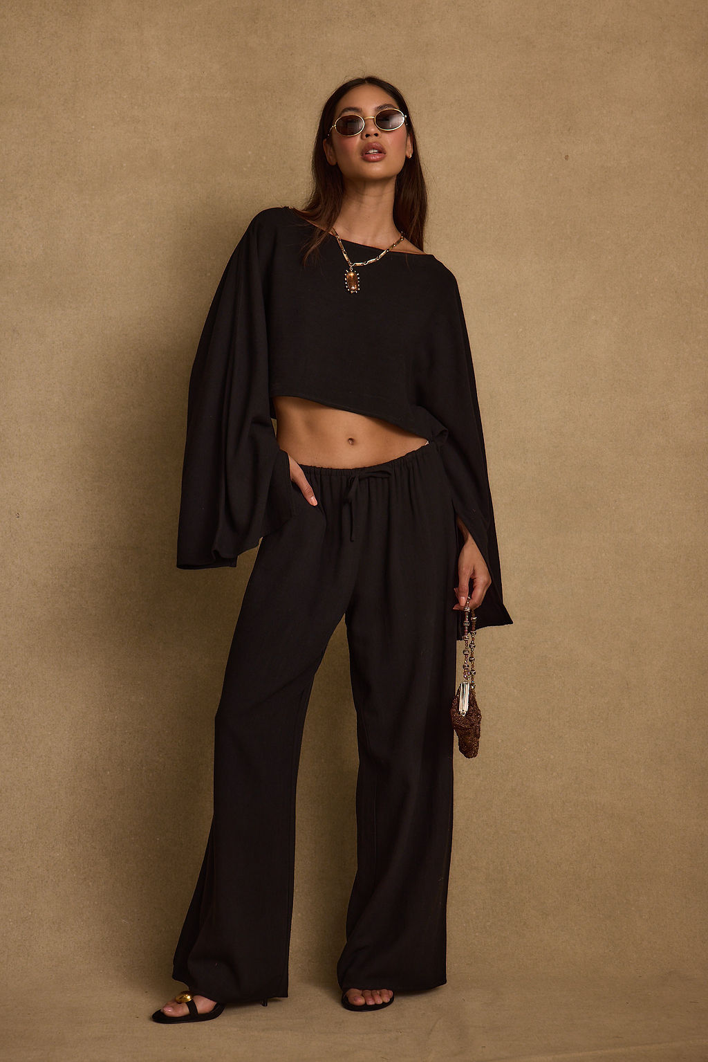 Black linen pants with refined accents, a black lace pants standout.