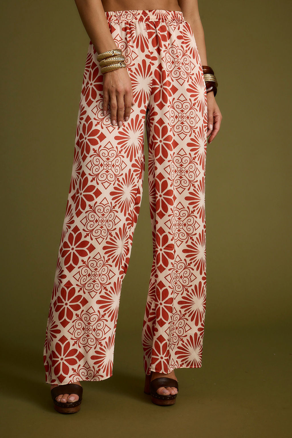 Detail shot of the Cubana Rust Satin Pants highlighting the satin elements.