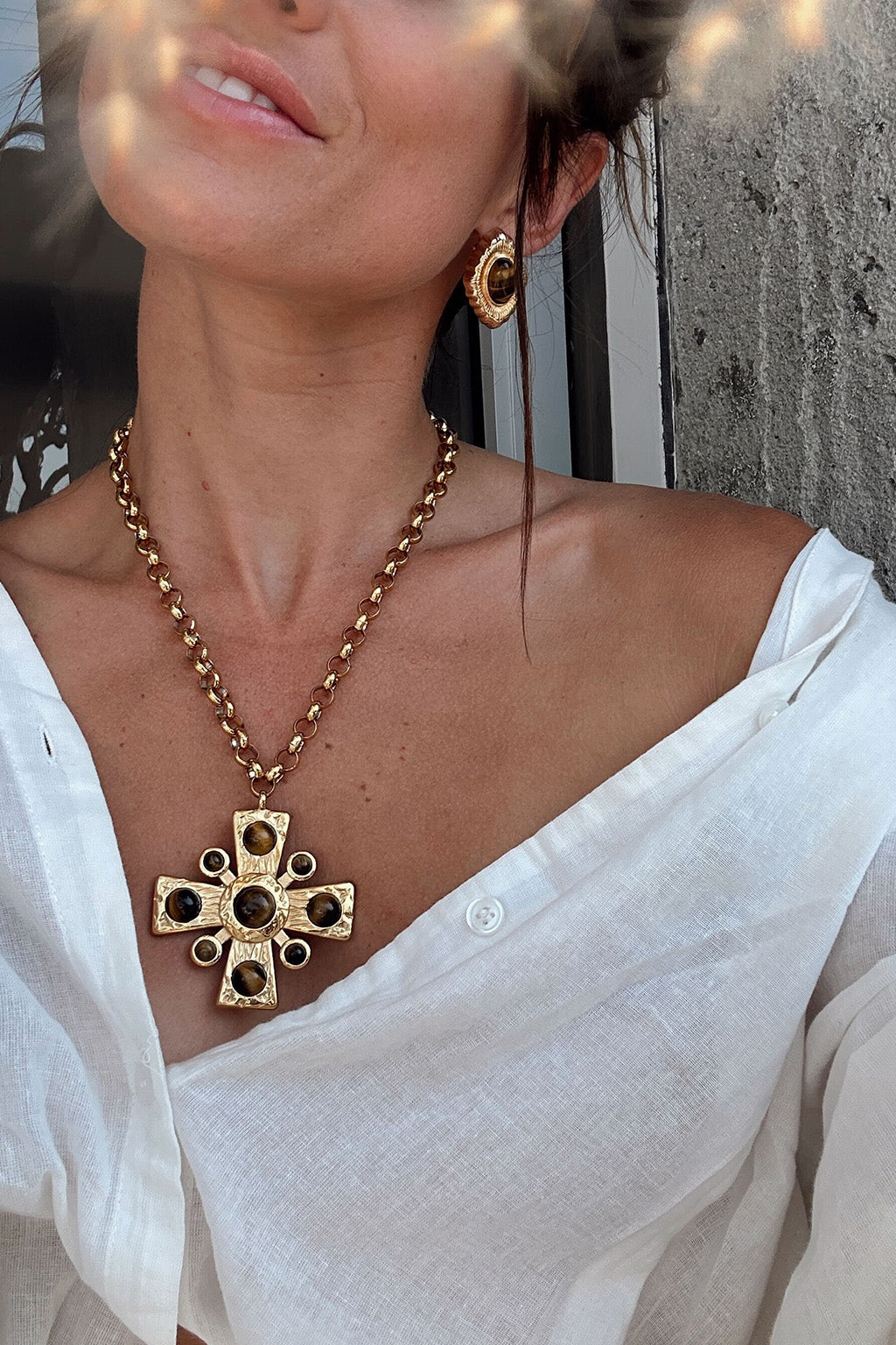 Styling option for the Catania Gold Cross Necklace shown with a complementary outfit.