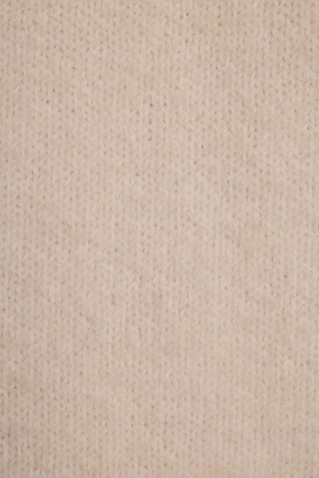 Cream knit sweater dress fabric close-up showing soft fuzzy texture and ribbed collar