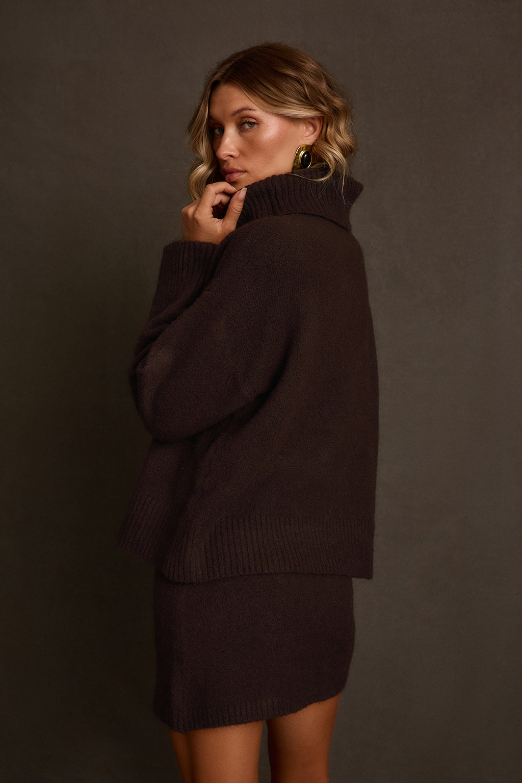 Fall sweater back view showing oversized silhouette and ribbed turtleneck collar