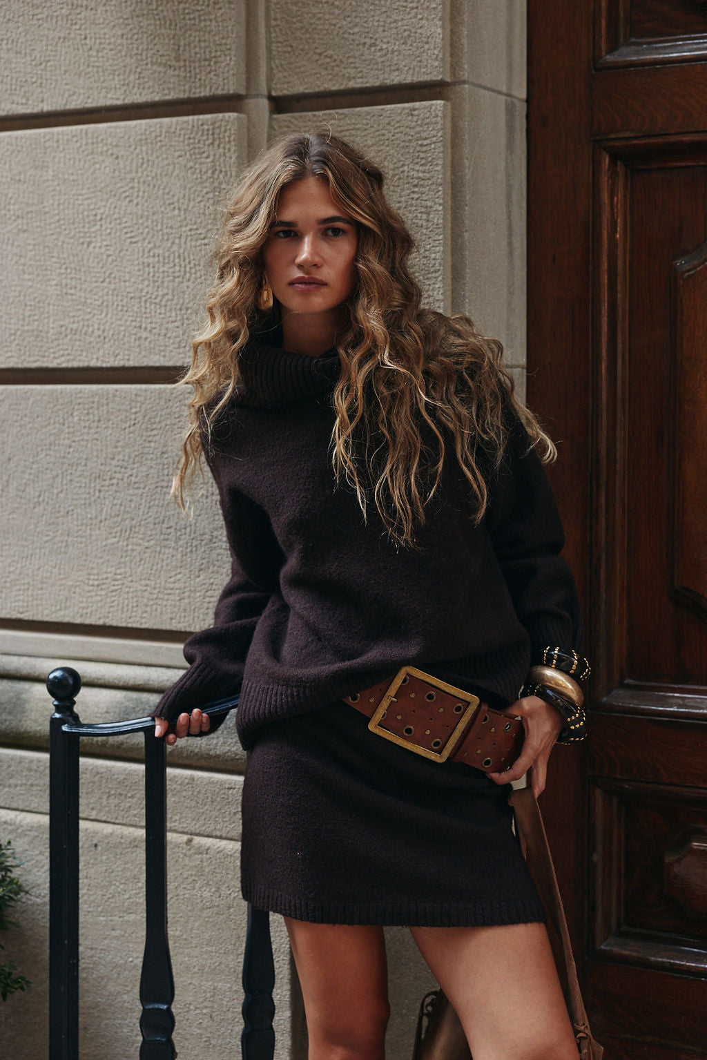 Sweater mini skirt paired with espresso turtleneck and cognac studded faux leather belt