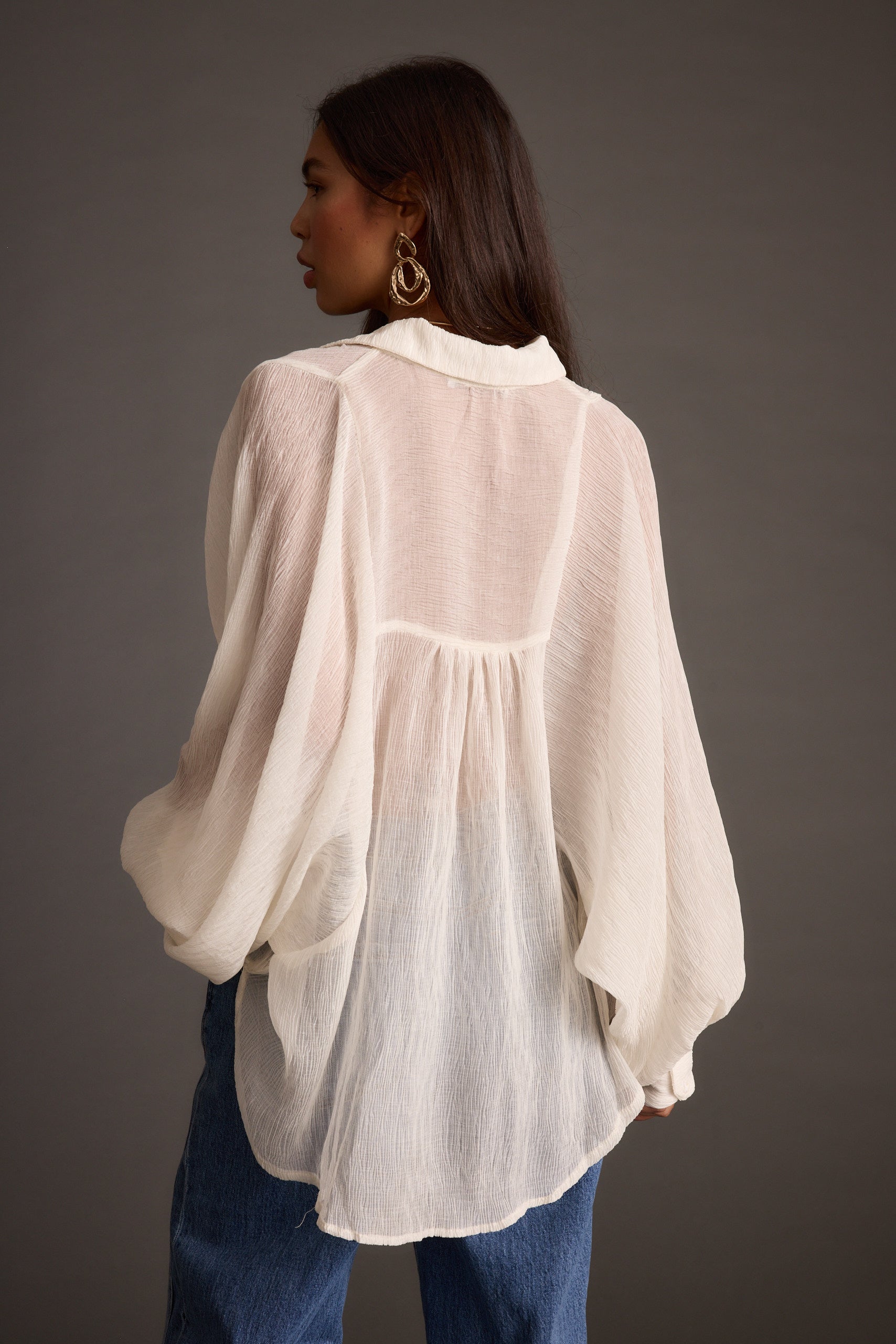 Alternate angle of the ivory blouse highlighting the overall design.