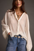 Ivory oversized blouse with refined detailing and a flattering silhouette.