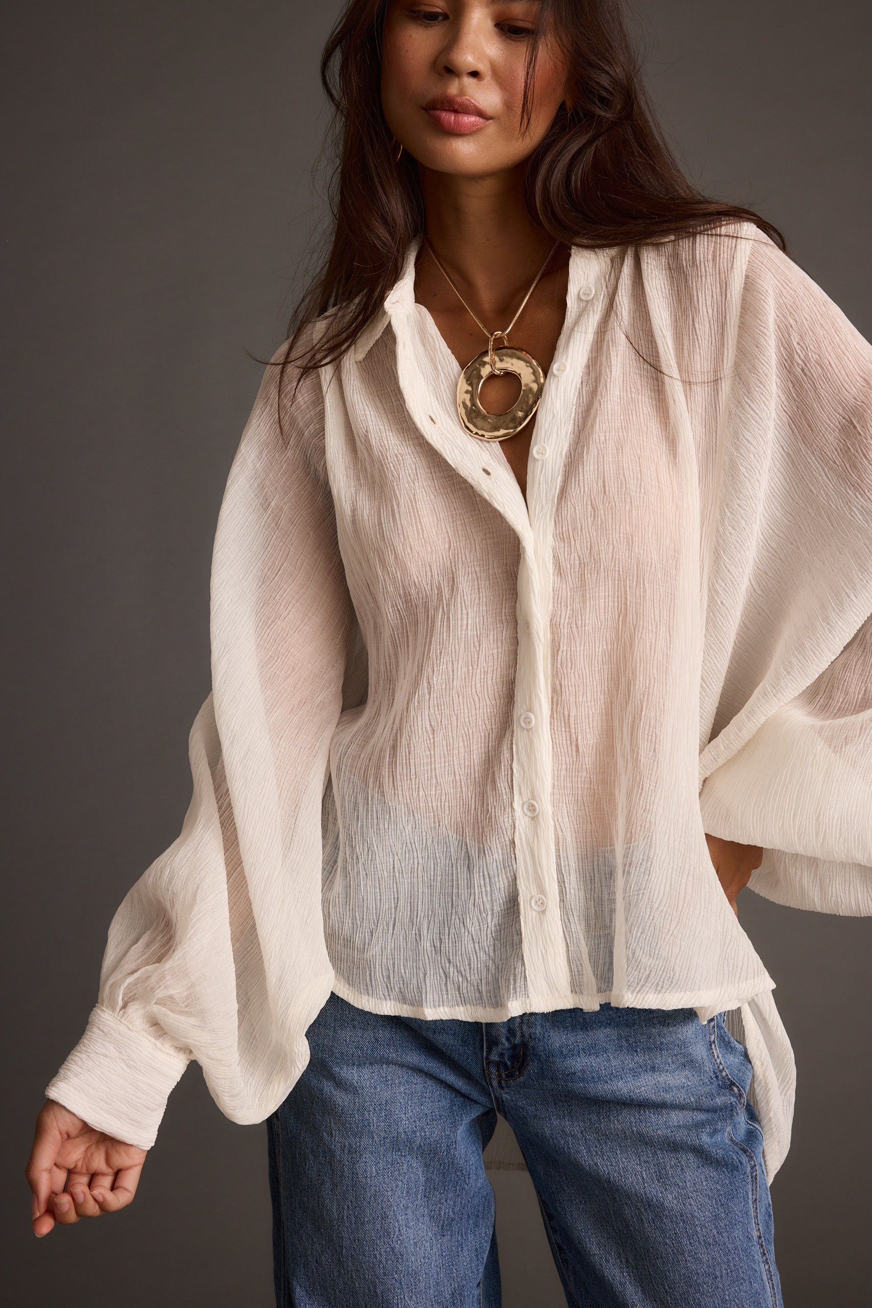 Lifestyle shot of the ivory blouse styled for day-to-night versatility.