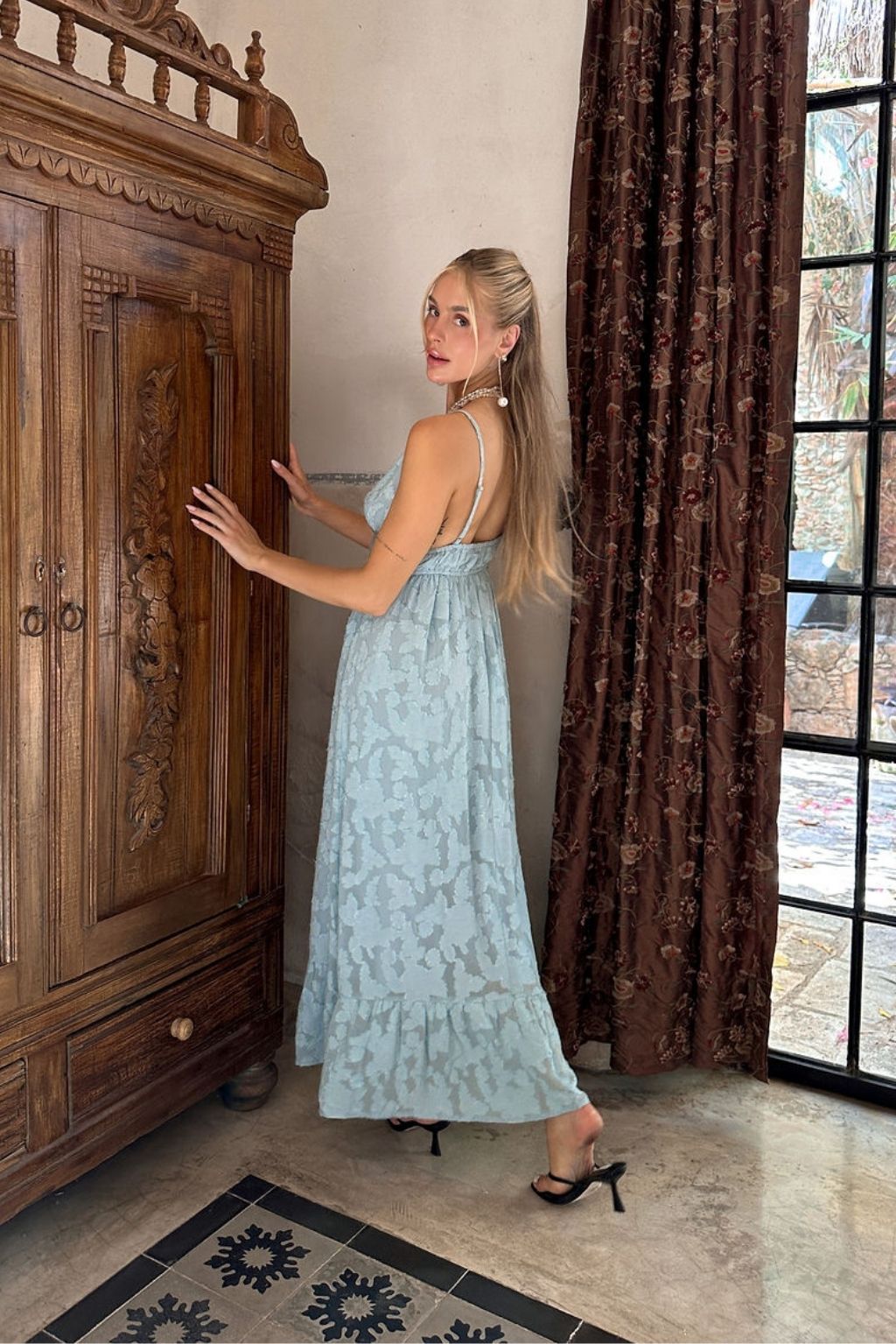 Alternate angle of the blue maxi dress highlighting the overall design.