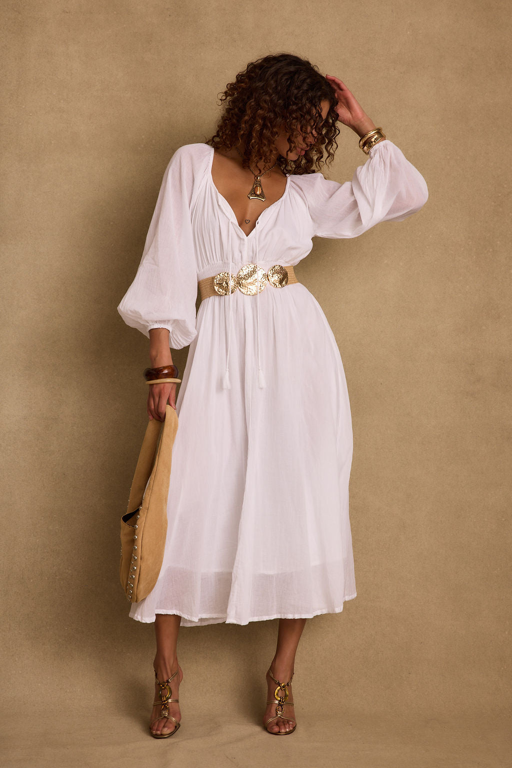 Lifestyle shot of the white maxi dress styled for day-to-night versatility.