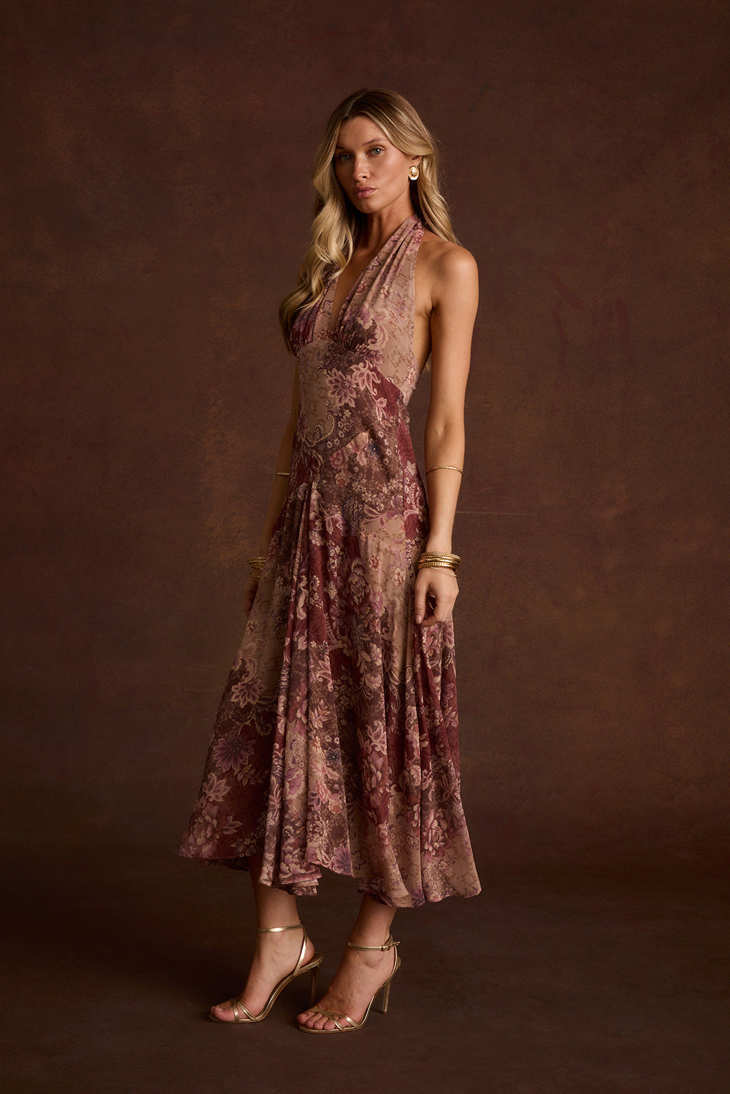 Darcy berry floral chiffon halter maxi dress styled with gold strappy heels and bangles.