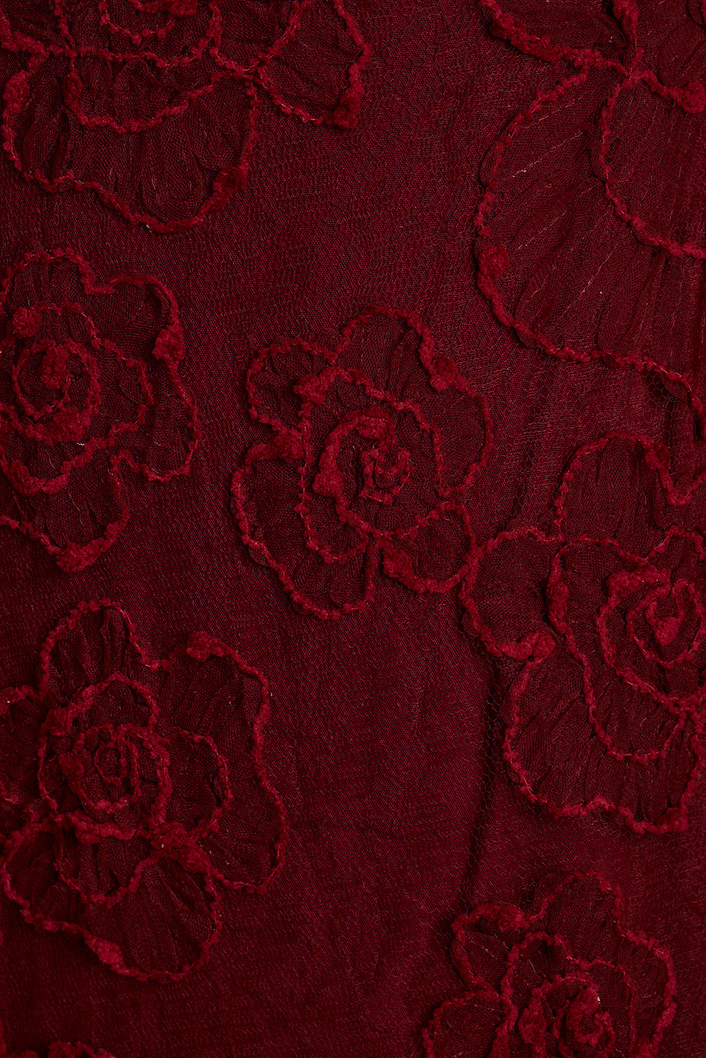 Close-up of burgundy rose floral lace appliqué fabric.