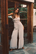 Model wearing the 12th Tribe Dahlia Blush Chiffon Jumpsuit, a blush chiffon one-piece featuring a lightweight draped silhouette and flowy wide-leg design, styled for weddings, bridal events, and spring or summer occasions