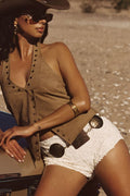 Model wearing the 12th Tribe Dune Coin Statement Belt, a copper-and-gold chain statement belt featuring textured metal detailing and a lobster clasp closure, perfect for layering over dresses, skirts, or high-waist trousers to elevate everyday outfits, evening looks, and festival-ready ensembles