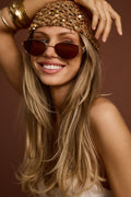 Model wearing the Desert Soul Gold Rimmed Sunglasses, featuring chic gold-rimmed frames and stylish lenses, perfect for adding a polished, modern touch to summer outfits, beach days, and festival-ready looks