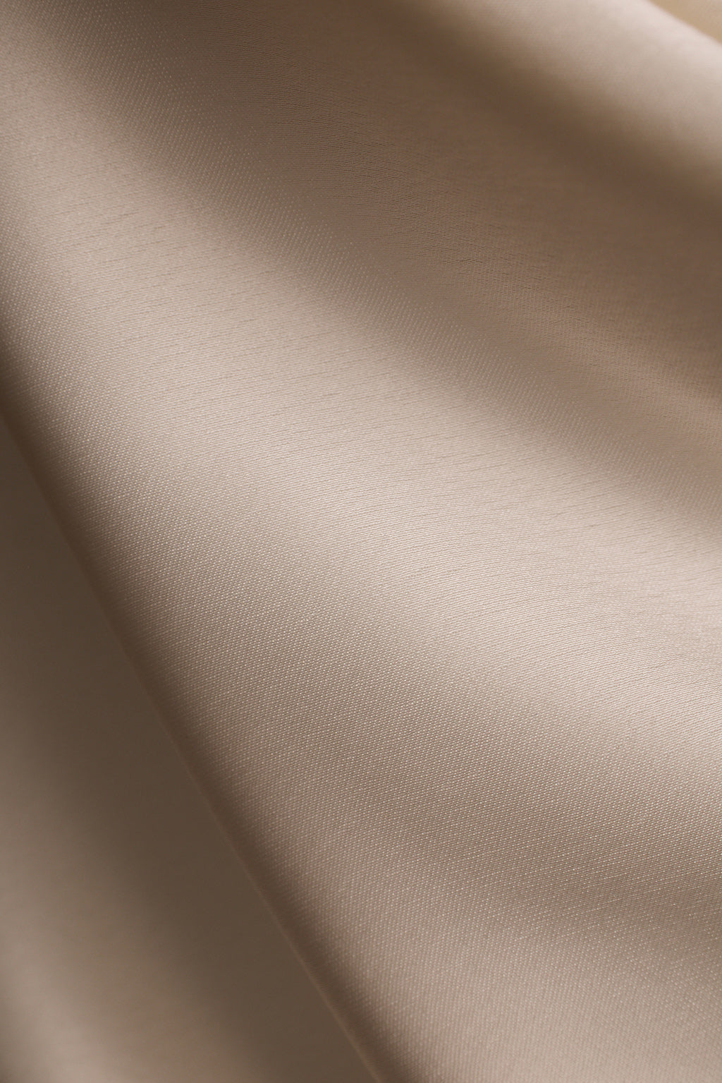 Close-up of ivory satin fabric with a soft sheen.