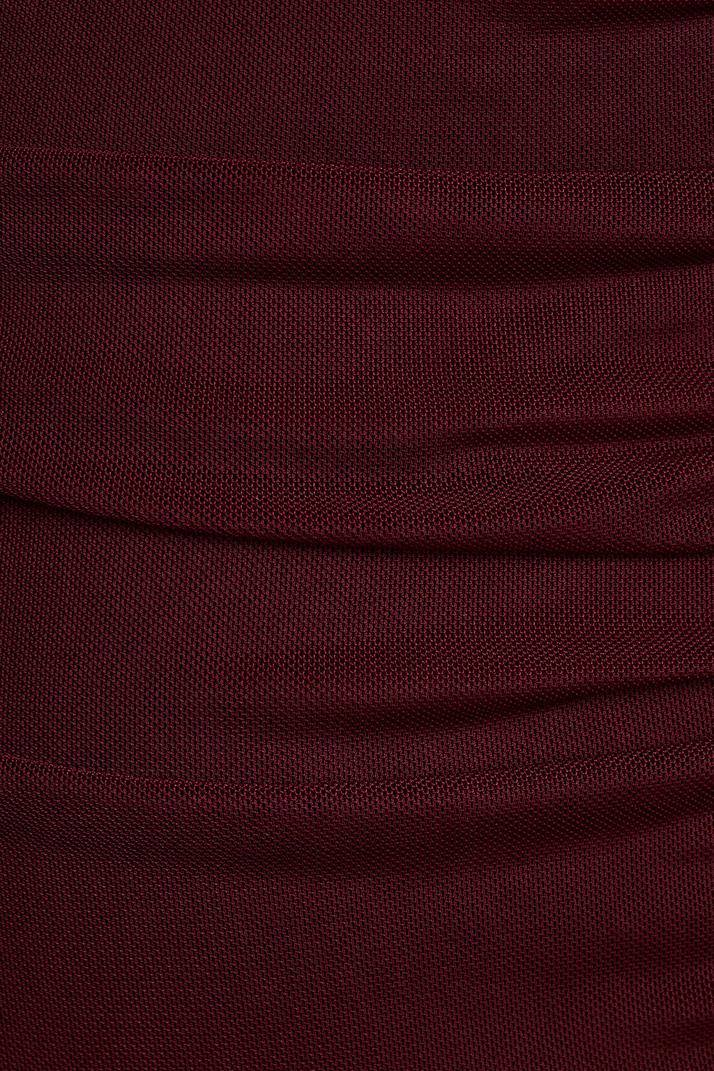 Close-up of burgundy mesh fabric with soft draped folds.