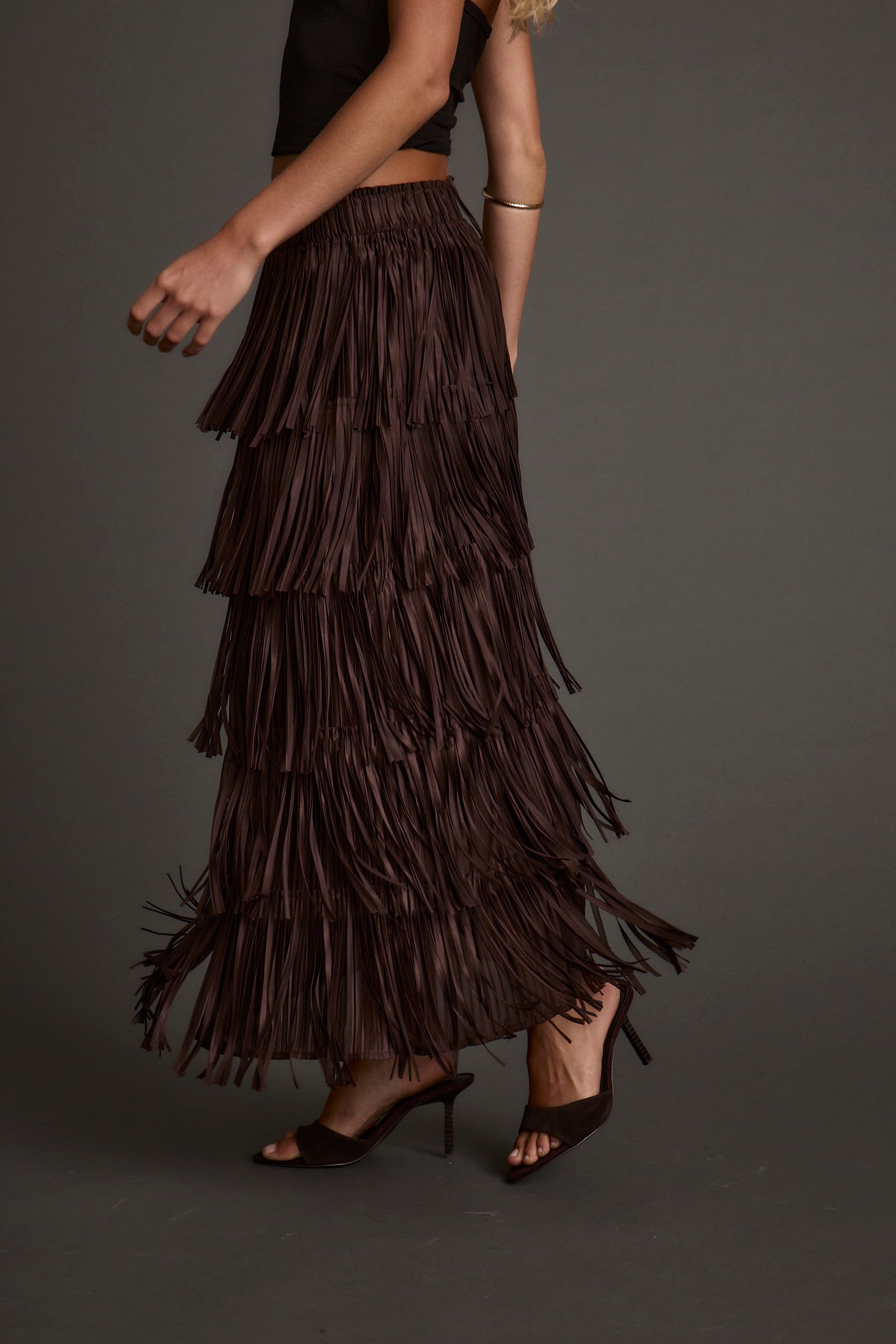 Lifestyle shot of the espresso maxi skirt styled for day-to-night versatility.
