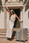 Ivory satin maxi skirt with a bias-cut flare, worn with a cowl halter top.