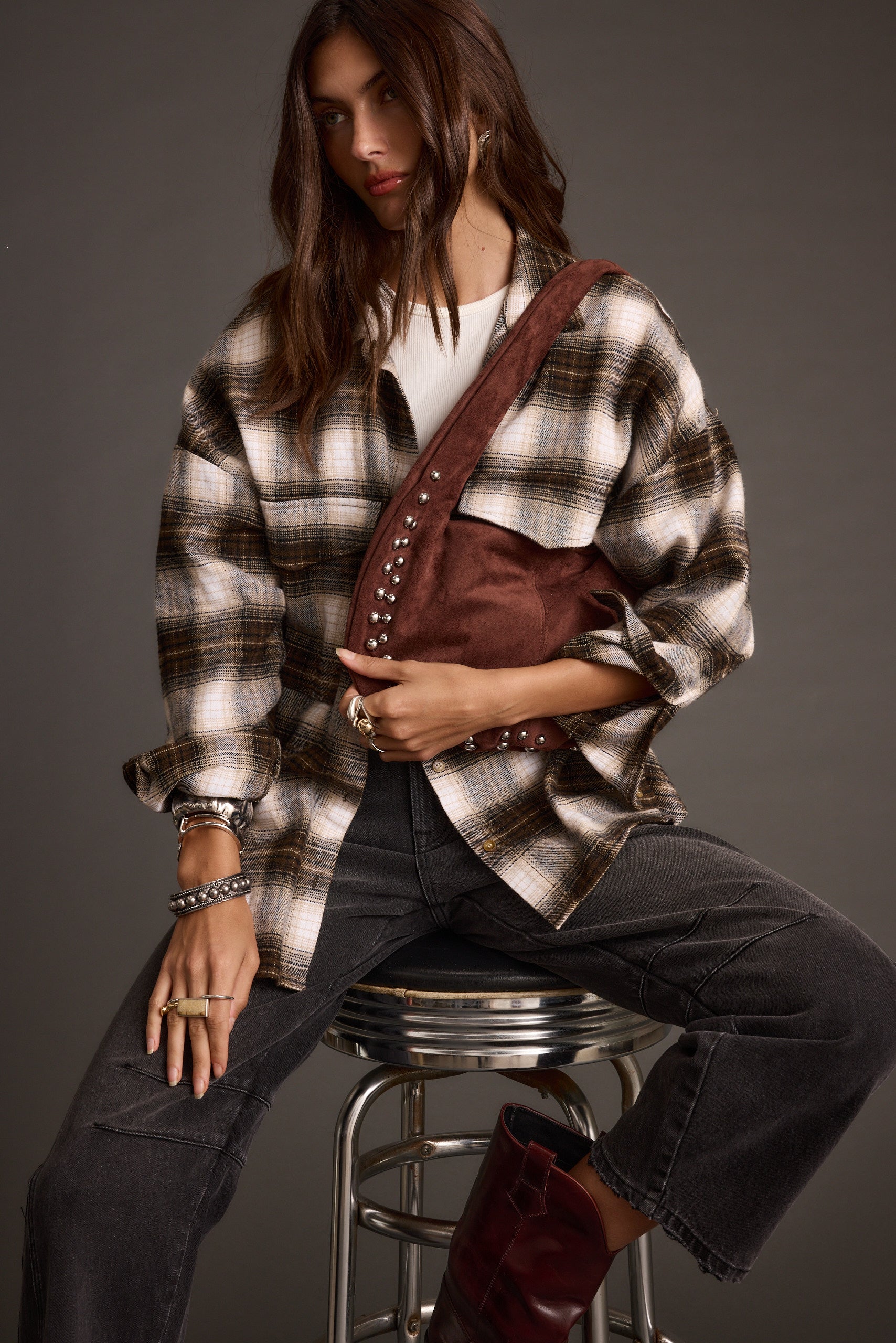 Detail shot of the Emery Mocha Studded Faux Suede Bag highlighting the design elements.