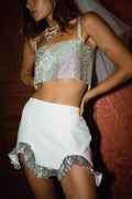 White sequin ruffled mini skirt with refined accents, a white sequin dress essential.