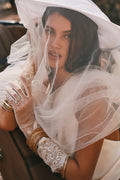 Sheer ivory tulle gloves with scalloped floral lace cuffs, shown worn with stacked gold bangles.