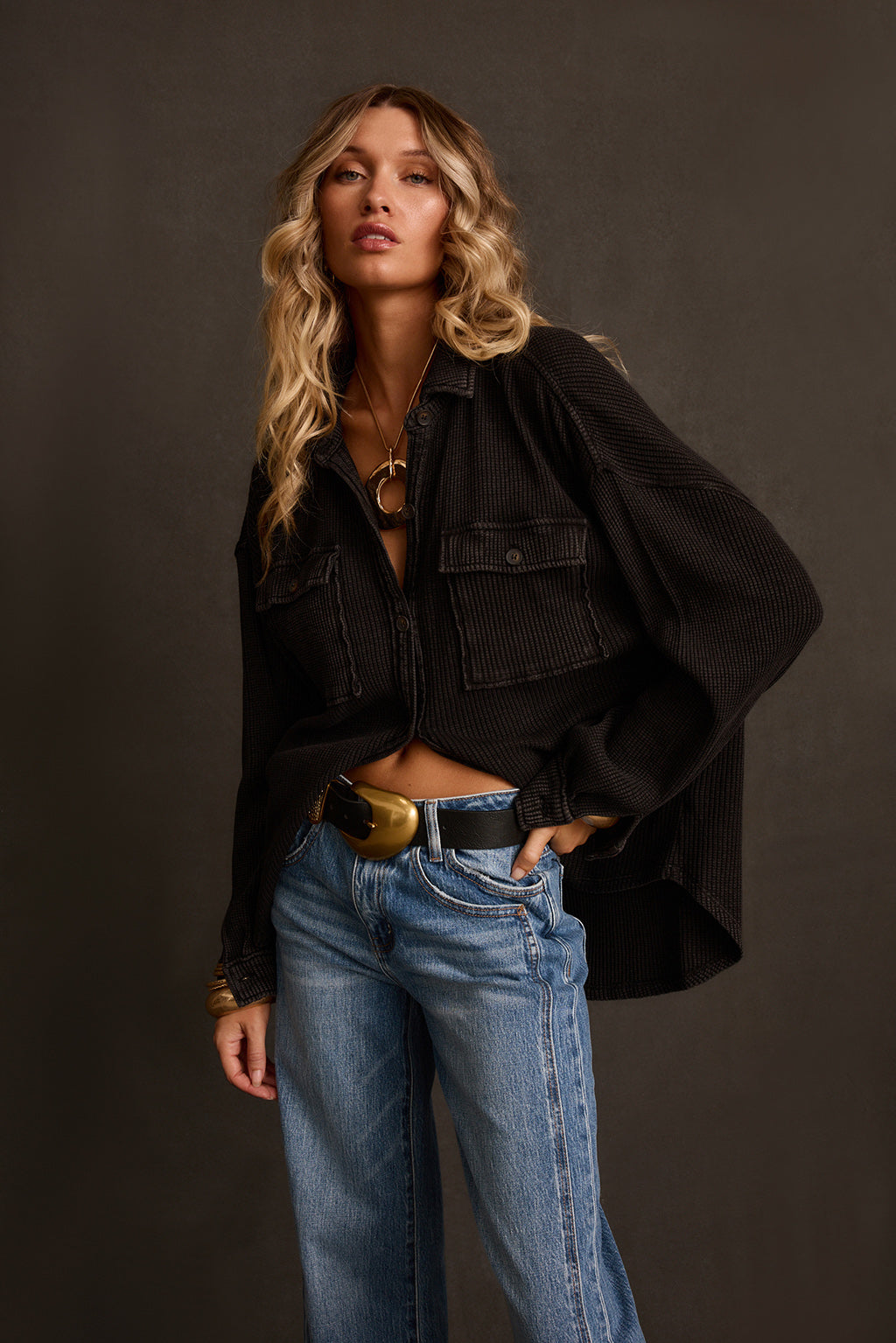 Shacket styled outdoors open over white tank, cuffed jeans, and western belt
