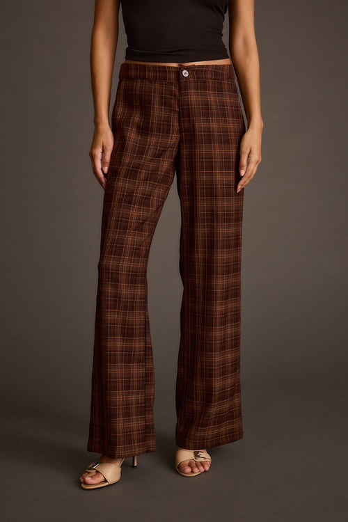 Front view of mocha plaid wide-leg pants with a button closure and heeled sandals