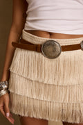 Model wearing the 12th Tribe Free Range Pendant Faux Leather Belt, a faux leather belt featuring a circular brushed silver buckle, round silver along the strap, and an adjustable fit, perfect for layering over dresses, skirts, or high-waist trousers to elevate everyday outfits, evening looks, and festival-ready ensembles