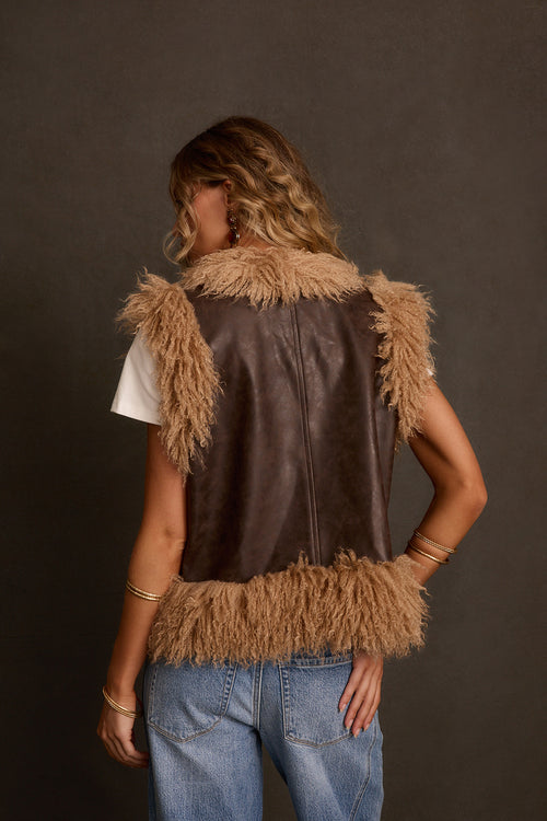 Fall vest back view showing smooth leather back panel and faux fur trim at shoulders