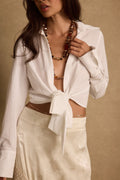 White top with elegant accents, a white feather top essential.