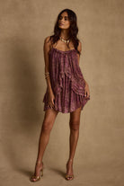 Model wearing the 12th Tribe Golden Hour Raspberry Ruffle Mini Dress, featuring a vibrant raspberry hue, playful ruffle details, and a fitted mini silhouette, styled with strappy heels and statement necklace for bachelorette parties, and evening outings