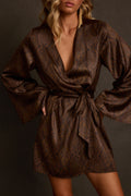 Satin mini dress in mocha with deep V wrap neckline, bell sleeves, and medallion print