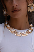 Gold pearl necklace with refined detailing and an elegant finish.