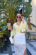 Yellow ruffled blouse with refined detailing and a flattering silhouette.